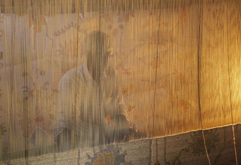 hand made carpet making weavier in a loom