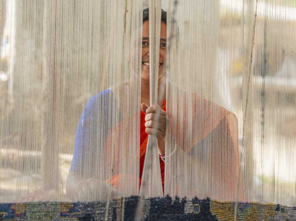 women weaver working on a handmade carpets